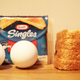 Eggs, Kraft singles, and sliced bread on a countertop